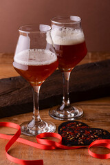 Two full glasses of beer for lovers. Octoberfest. Valentines day. Happy couple concept. Bright red background.