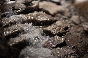 Tilt shift lens used on stone stair waterfall giving miniature effect.