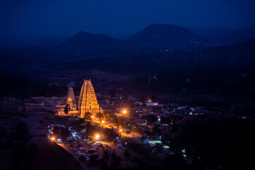 a view of Virupaksha Temple, a famous and ancient Shiva Temple built by Vijayanagara Rulers in 7th Century AD, shot from Mathanga Hill just before sunrise during the blue hour