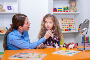 Child with speech therapist on therapy