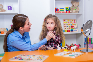 Fototapeta premium Child with speech therapist on therapy