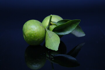 Natural fresh Lime closeup isolated on black background. Selected Focused