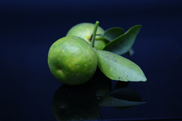 Natural fresh Lime closeup isolated on black background. Selected Focused