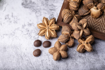 Obraz na płótnie Canvas A pile of dried Sacha Inchi nuts. Natural background in lighting studio
