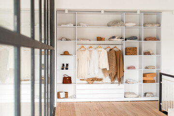 Modern interior, beautiful wardrobe with clothes