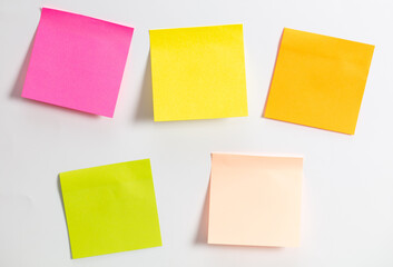 Colored papers hang on a white background.