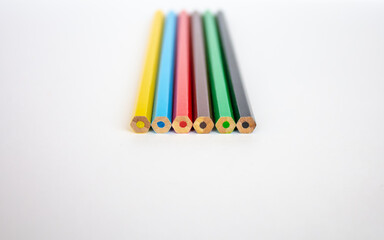 row of color pencils isolated on white background, blur , copy space