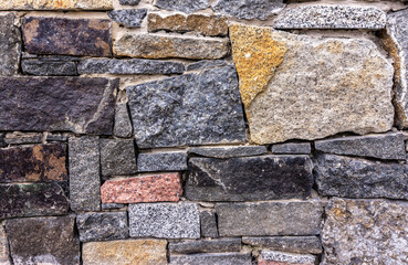 The texture of the stone wall. Part of a stone wall, for background or texture