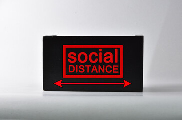 Text SOCIAL DISTANCE made of wooden block. New normal after covid-19 pandemic with social...