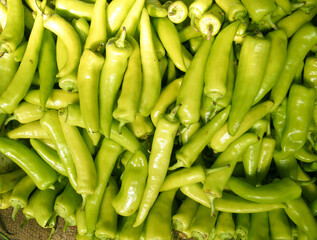 A pile of green banana peppers.