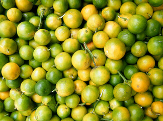 Many Fresh Raw limes on a Market Stall