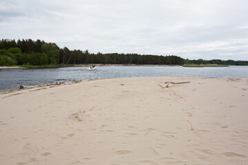 City Carnikava, Latvia. A motorboat floats on the river with people.
