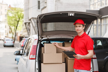 Checking packages in car. Auto delivery with courier to home