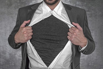 Business man rips open his shirt to show his t-shirt - Image