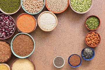 Assorted different of legumes, beans, grains and seeds in bowls. Top view, flat lay, copy space