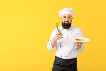 Handsome male chef on color background
