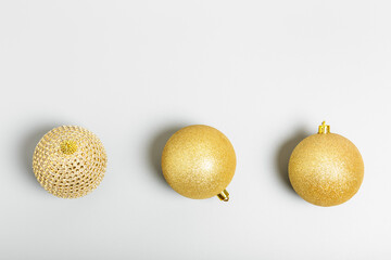 three golden christmas balls on gray background. New Year or Christmas concept. top view, copy...