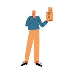 Man architect standing and holding future building example in hand