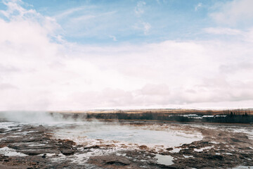 Geyser Valley in the southwest of Iceland. The famous tourist attraction Geysir. Geothermal zone Haukadalur. Strokkur geyser on the slopes of Laugarfjall hill.