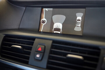 Interior of premium car backup parking assistant system with sensors on screen. Driver assistance...