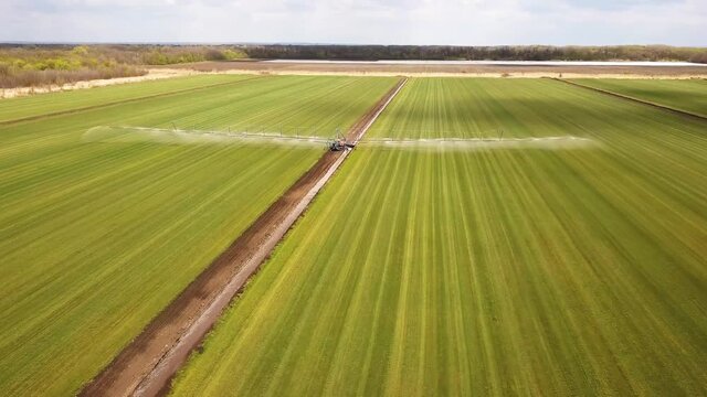 Farm tactor spraying agricultural fields.