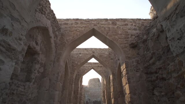 Dollying in and tilting down through teh ancient arches of the Bahrain Fort