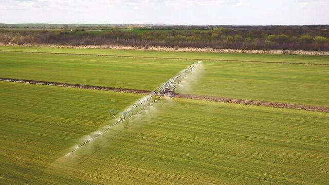 Farm tactor spraying agricultural fields.