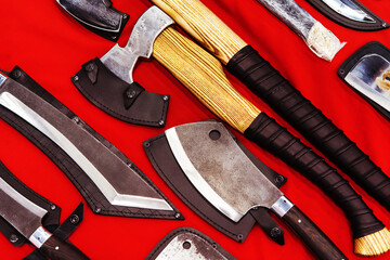 Handmade decorative axes in retro style on a red background