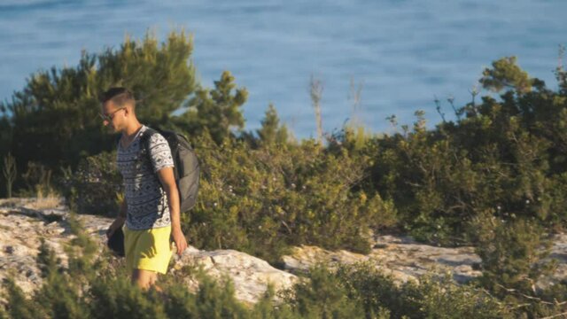 4k footage of photographer walking with his camera in his hand in wilderness.
