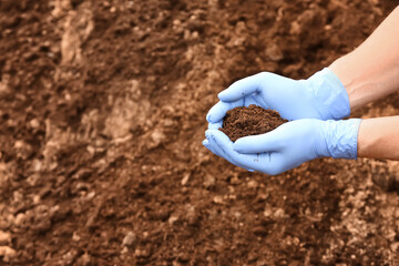Man testing rich soil outdoors