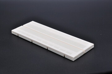 prototype board or breadboard for electronic circuit testing isolated on black background