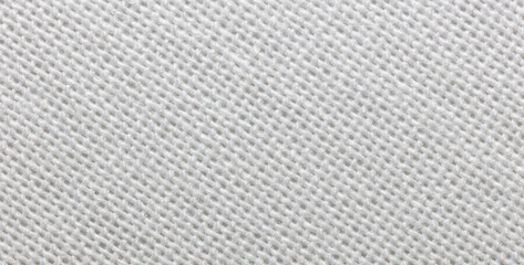 Close-up view of a piece of white fabric. Macro shot. Texture.