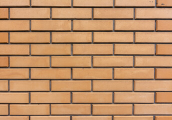 A neatly laid out brick wall. Brickwork.