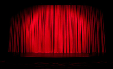 Red stage curtain with spotlight and with contours of seats