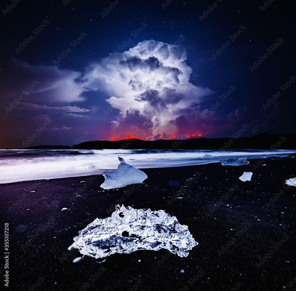 Poster Incredible piece of the iceberg sparkle on black sand.