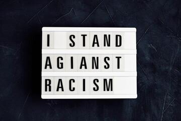 I stand against racism  text on light box on dark background