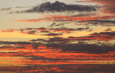 Deep red clouds and warm colored sky at sunset