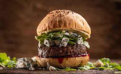 Beef burger with arugula, blue cheese and cranberry sauce