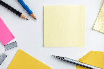 Office desk table pencil and post it on white background.