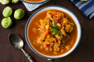 Soup with cabbage, brussel sprouts, sweet corn, pepper and tomatoes. Lecho.