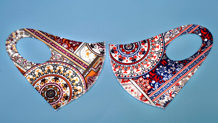 Batik design in scuba face mask pollution and corona virus protection isolated on blue. Batik known...