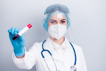 Closeup photo of infection viral doctor experienced nurse hold blood probe covid patient positive result wear coat mask facial plastic protection shield surgical cap isolated grey background