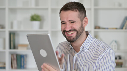 Portrait of Young Man Celebrating Success on Tablet