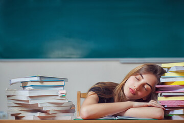 Girl student fell asleep over the books. Preparation for exams in school. Education in schools. Vitamin deficiencies for students. Young woman fell asleep while reading books at the table