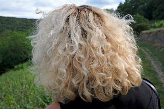 Blonde Woman With Curly Hair Seen From Behind