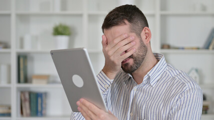 Portrait of Young Man Reacting to Loss on Tablet
