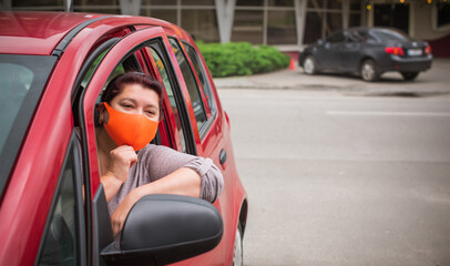 Fototapeta premium Social distance concept. Life people after quarantine. Middle aged plus size lady wear protective mask at street 