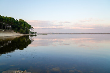 lacanau lake sunrise with sandy beach forest in nature Gironde france