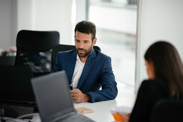 Businessman working on a project in the office. Young businessman working in office.