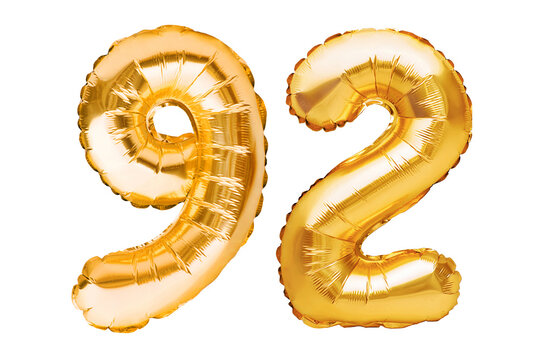 Number 92 ninety two made of golden inflatable balloons isolated on white. Helium balloons, gold foil numbers. Party decoration, anniversary sign for holidays, celebration, birthday, carnival